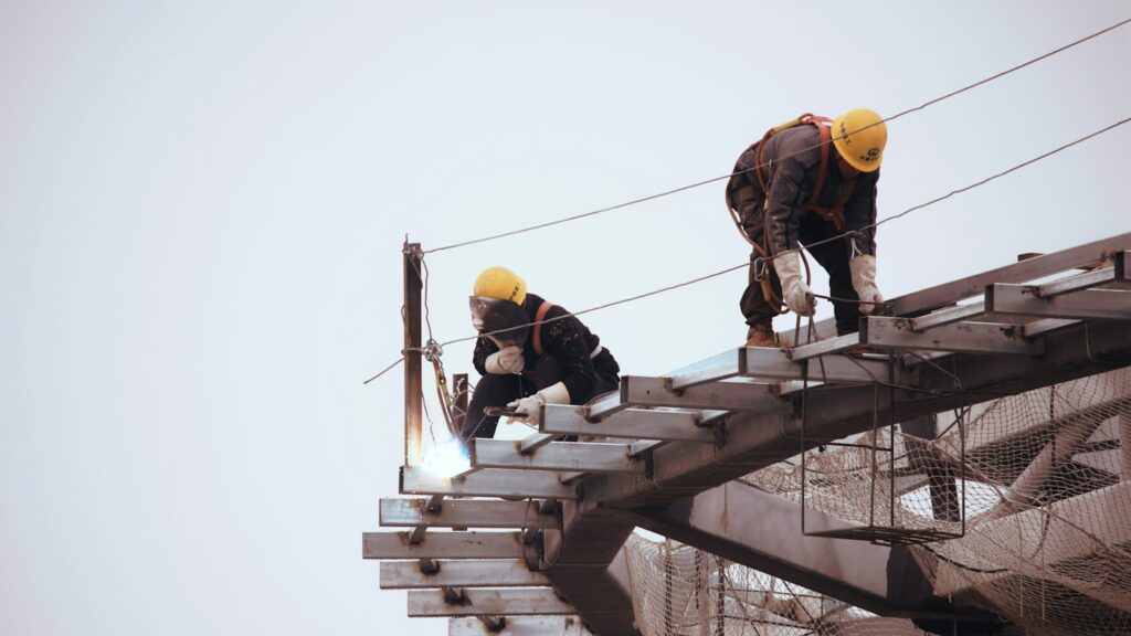Project supervisor in a hard hat on top of a building under renovation