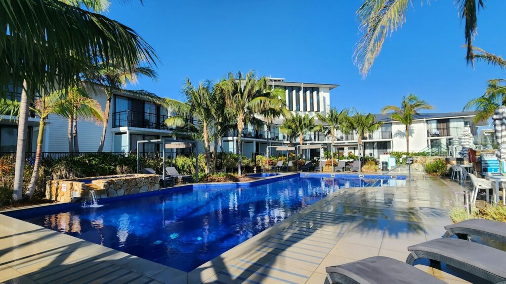 Resort-style pool deck with lounge chairs at a residential community